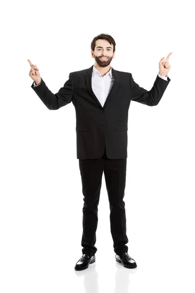 Happy businessman points his finger up. — Stock Photo, Image