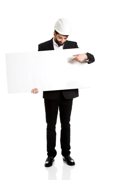 Engineer in helmet pointing on empty banner. — Stock Photo, Image