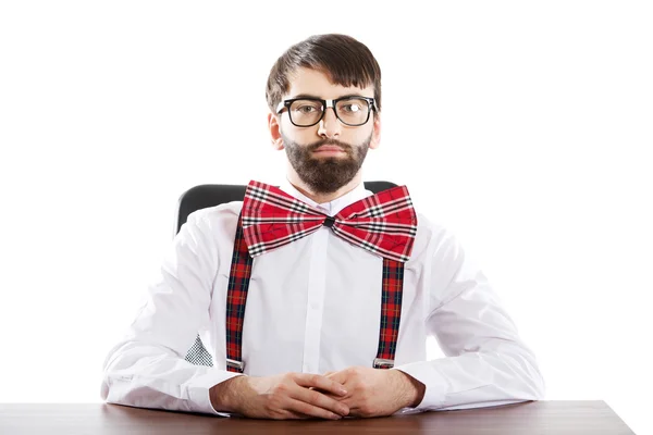 Young old fashioned man sitting by a desk. — Stock Photo, Image