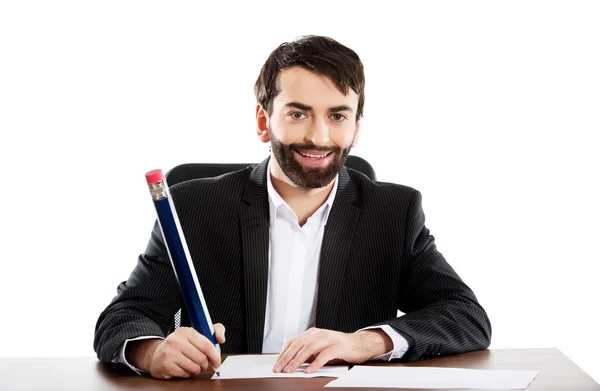 Happy businessman writing in the office — Stock Photo, Image