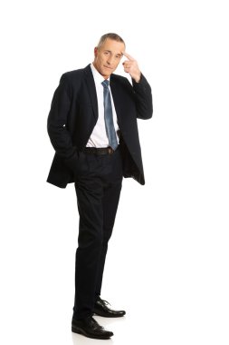 Full length businessman gesturing idiot sign clipart