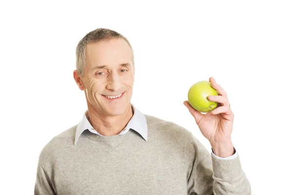 Mature man with an apple — Stock Photo, Image