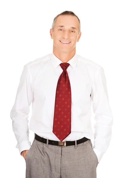 Smiling businessman with hands in pockets — Stock Photo, Image