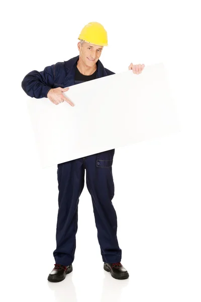 Happy worker presenting empty banner — Stock Photo, Image