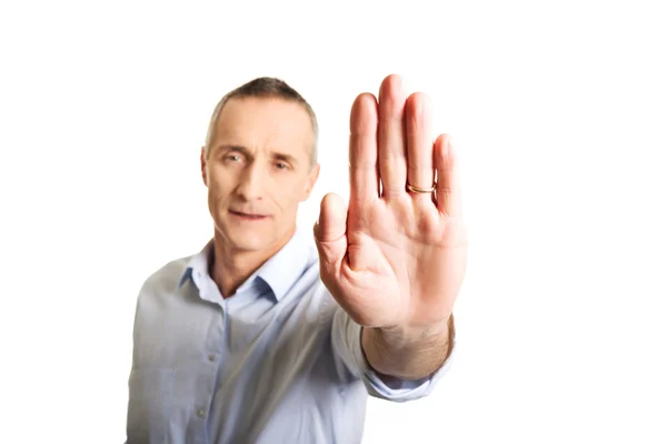 Portrait of mature man making stop sign with hand — Stock Photo, Image