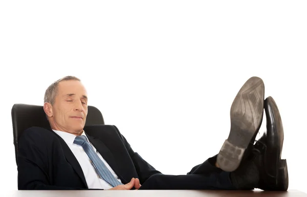 Mature businessman resting in armchair — Stock Photo, Image