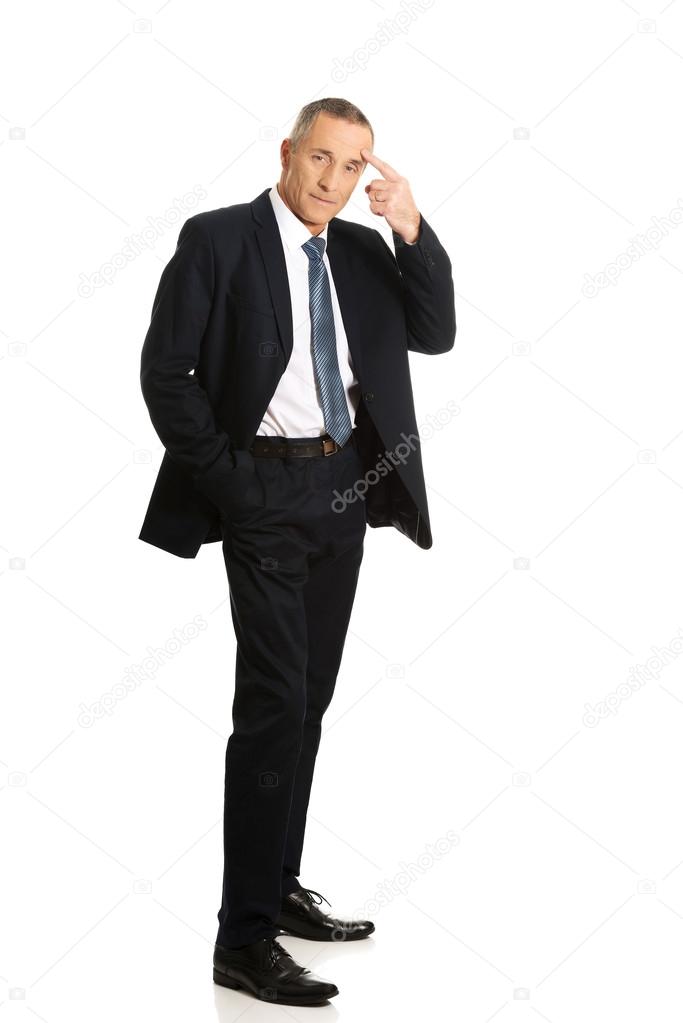 Full length businessman gesturing idiot sign