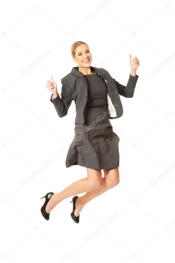 Cheerful jumping businesswoman
