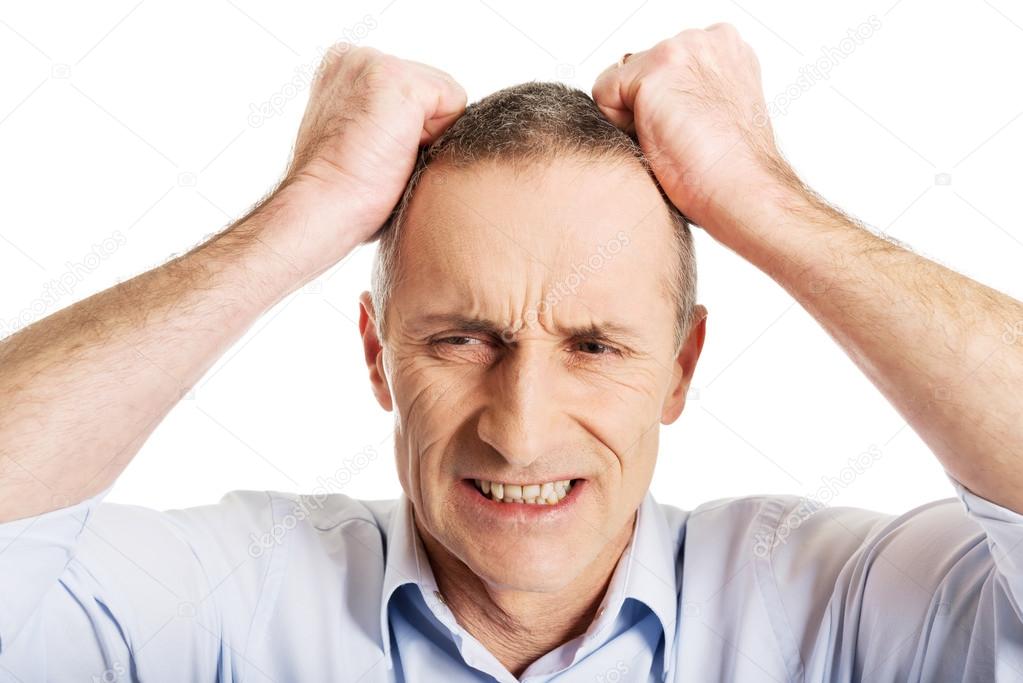Frustrated man pulling his hair