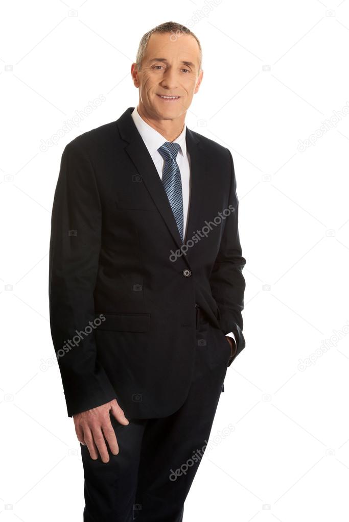 Smiling businessman with hand in pocket
