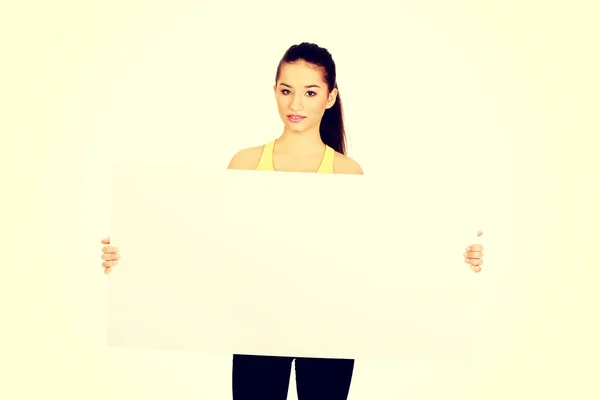Fitness woman with empty placard. — Stock Photo, Image