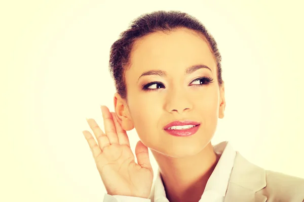 Beautiful businesswoman overhears. — Stock Photo, Image