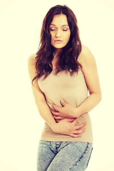 Woman suffering from severe pain in her tummy. — Stock Photo, Image