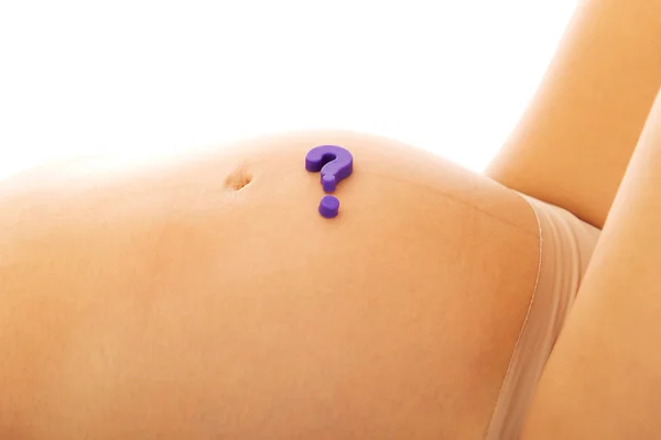 Belly of pregnant woman with question mark — Stock Photo, Image