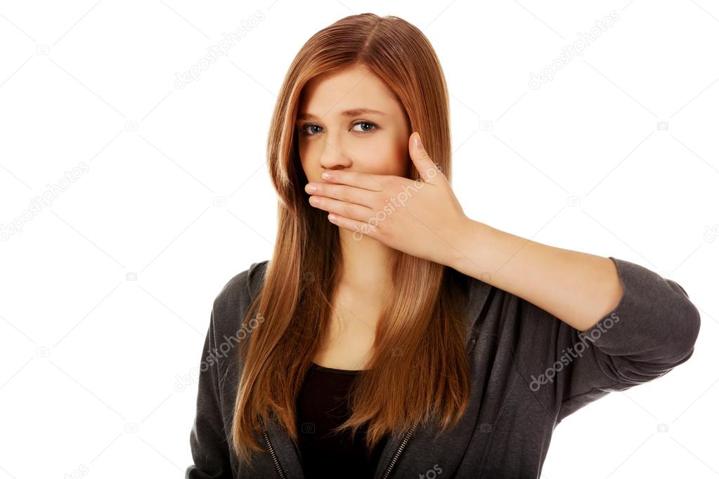 Teen woman covering her mouth with hand