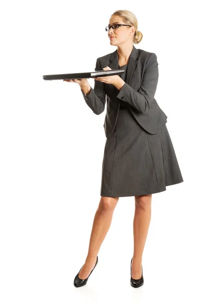 Businesswoman standing and holding laptop Royalty Free Stock Images