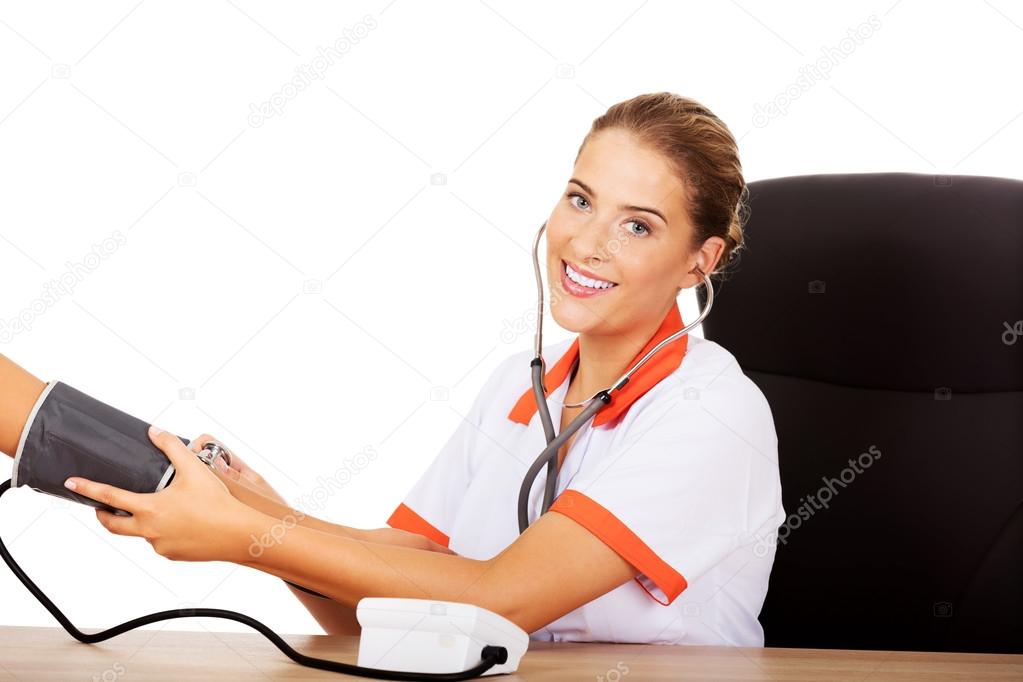 nurse checking blood pressure