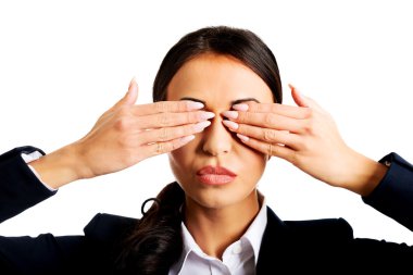 Businesswoman covering eyes with hands clipart