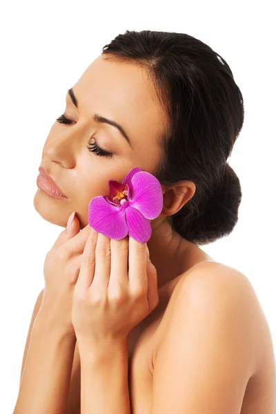 Kobieta z fioletowym orchidei i zamknięte oczy — Zdjęcie stockowe