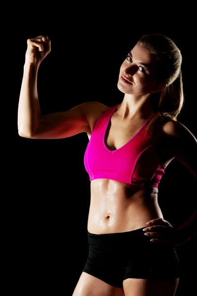 Woman shows her muscles — Stock Photo, Image