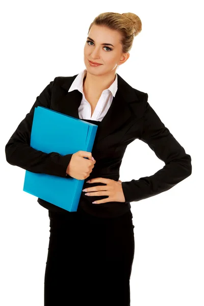 Smiling businesswoman holding a binder — Stock Photo, Image