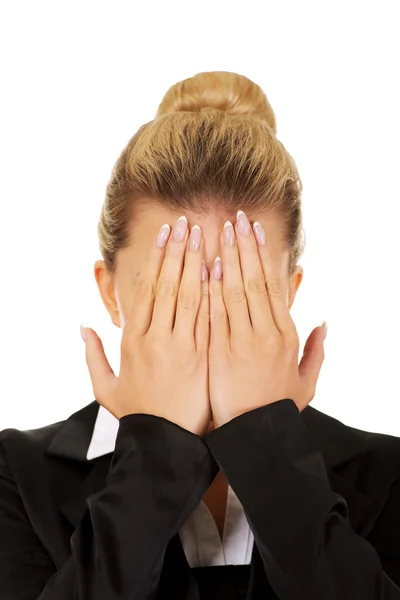 Businesswoman covering face with hands — Stock Photo, Image