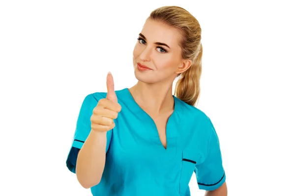 Mujer sonriente médico o enfermera con el pulgar hacia arriba —  Fotos de Stock