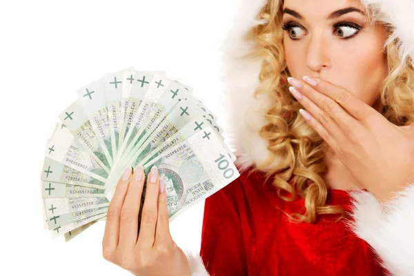 Shocked santa woman holding a clip of polish money — Stock Photo, Image