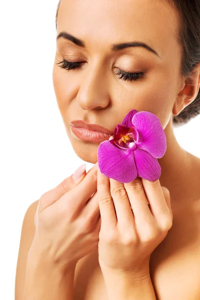 Woman with purple orchid and closed eyes Royalty Free Stock Photos