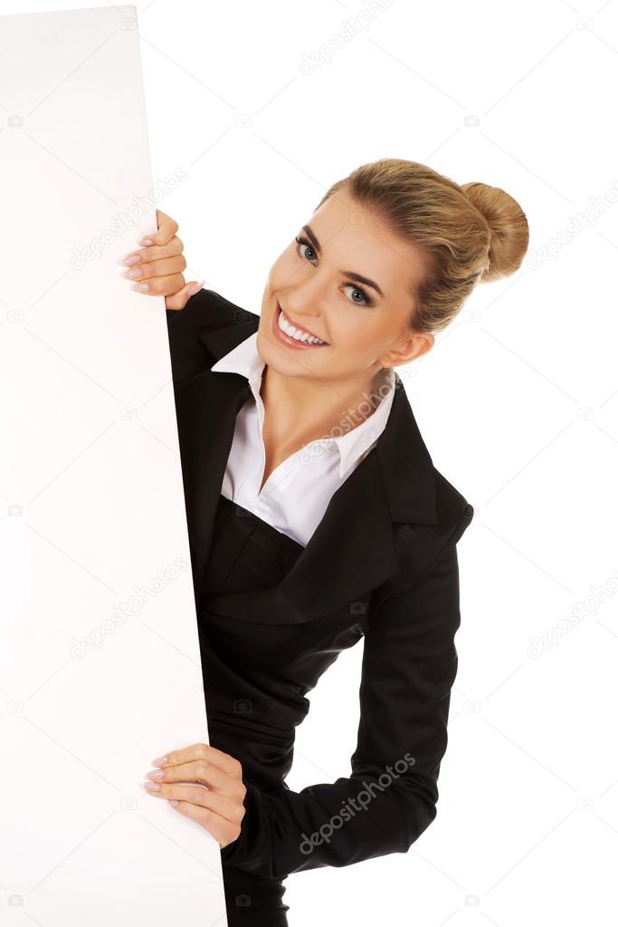 Happy businesswoman holding empty banner.