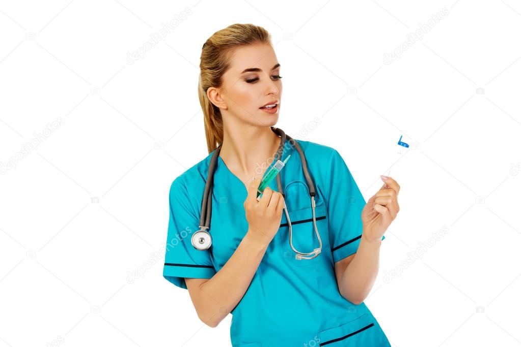 Female nurse with two syringes in the hands