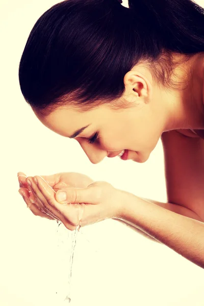 Woman washing her clean face. Stock Picture