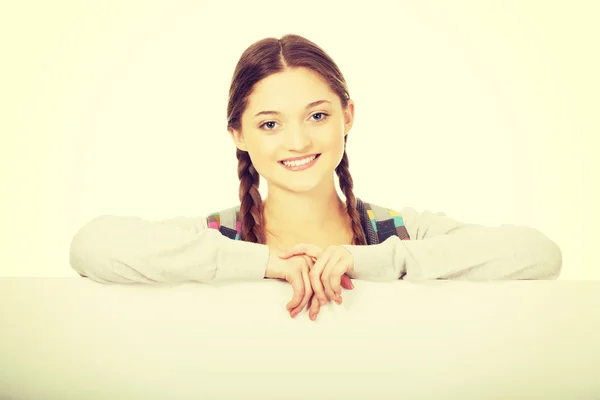 Young woman with blank billboard. — Stock Photo, Image