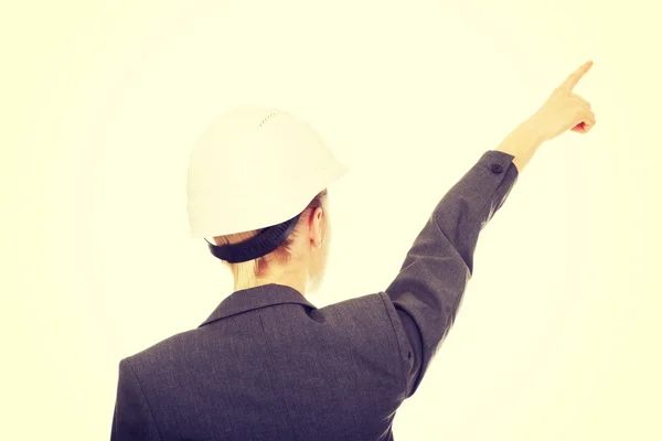 Businesswoman in hard hat pointing up. — Stock Photo, Image