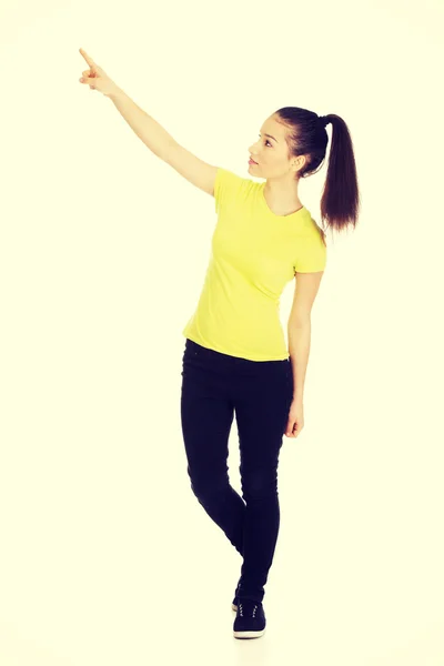 Young woman pointing up. — Stock Photo, Image