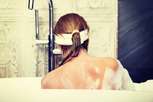 Bathing woman sitting in bath. Royalty Free Stock Photos