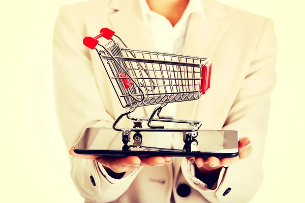 Businesswoman with shopping cart and tablet. — Stock Photo, Image