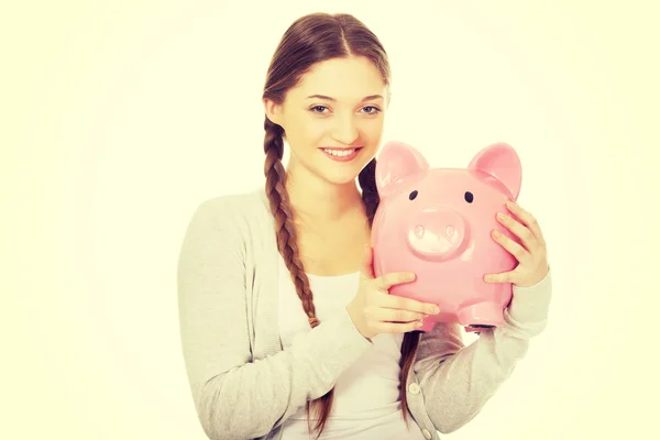 Teenage woman holding piggybank. — Stock Photo, Image