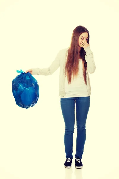 Young woman holding a full garbage bag. — Stock Photo, Image