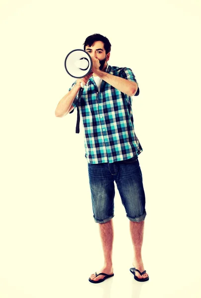 Jeune homme criant à travers le mégaphone . — Photo