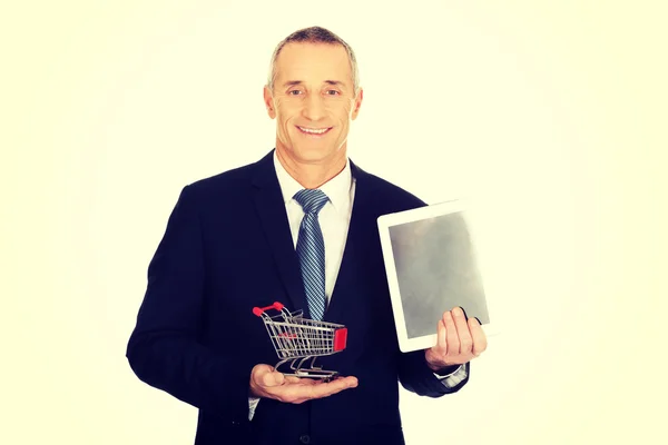 Retrato hombre de negocios con carrito de la compra y tableta —  Fotos de Stock