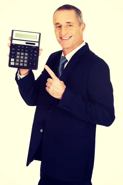 Happy businessman pointing on calculator — Stock Photo, Image