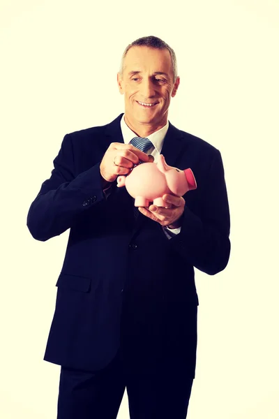 Cheerful businessman holding piggybank — Stock Photo, Image