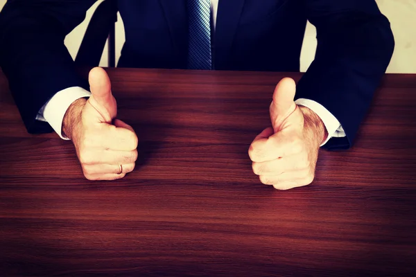 Closeup of businessman thumbs up on the desk — Stock Photo, Image