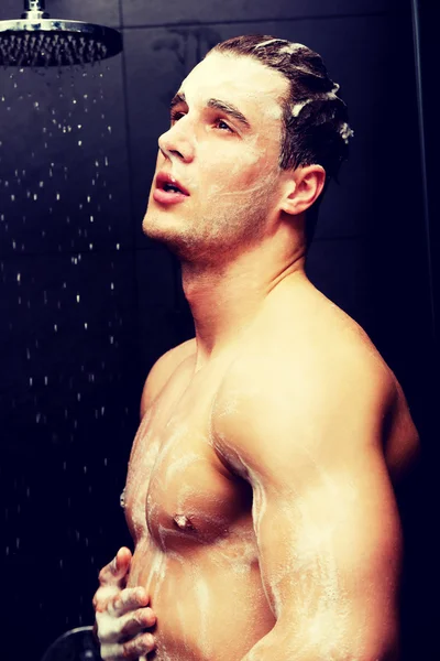 Handsome man washing himself with soap. — Stock Photo, Image