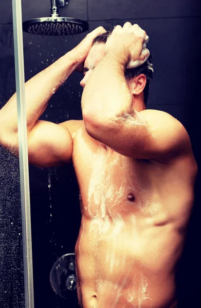 Pria tampan mencuci dirinya dengan sabun . — Stok Foto