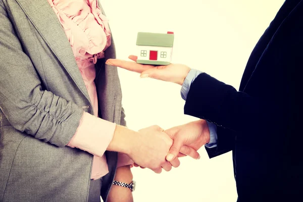 Businesswoman giving a house to her partner. — Stock Photo, Image