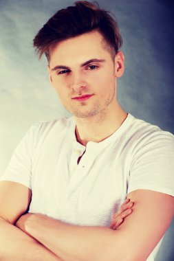 çapraz kolları olan kendine güvenen delikanlı.