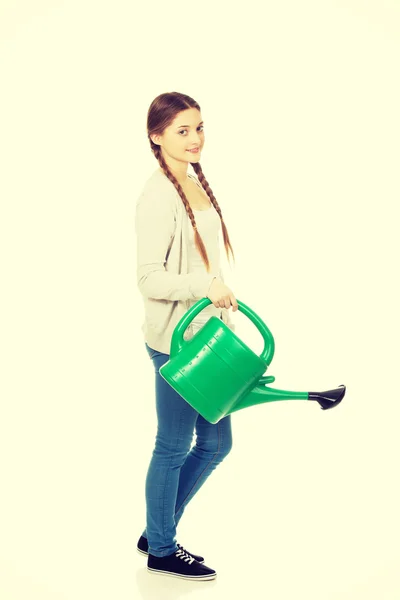 Teen woman with watering can. — Stock Photo, Image