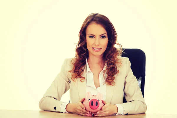 Business woman with a piggybank. — Stock Photo, Image